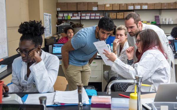 Students looking at a document in a laboratory