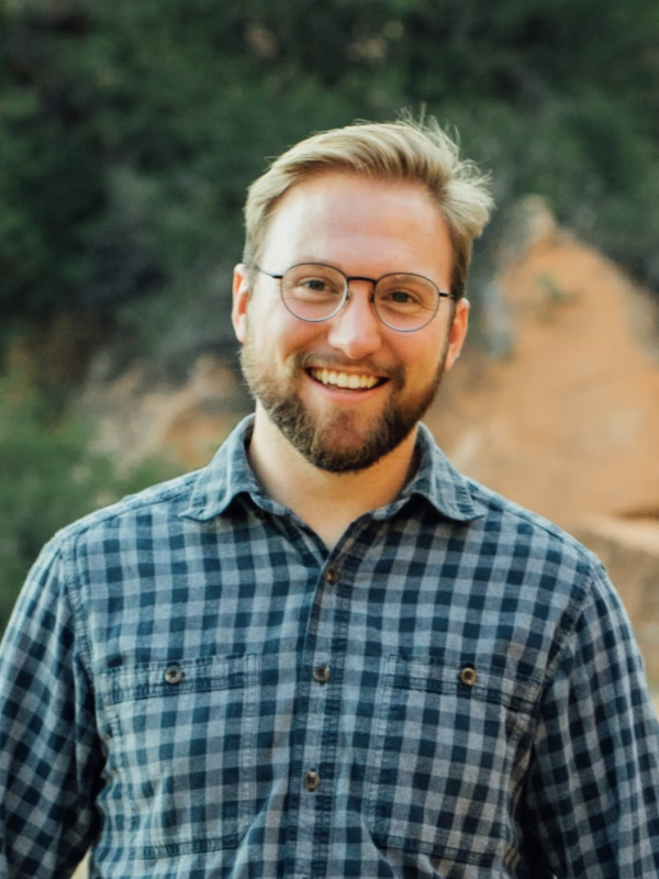 Headshot of a man wearing glasses, outdoors