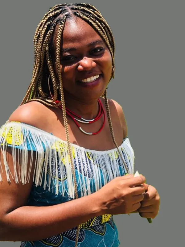 A smiling woman in front of a gray background